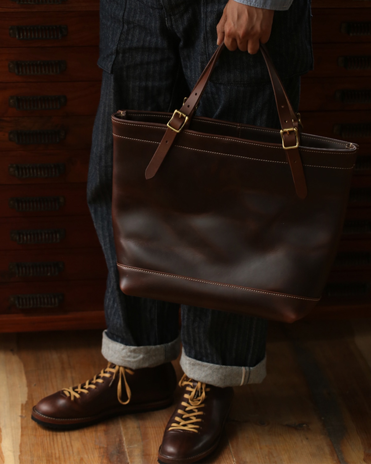 A brown leather tote bag styled for everyday carry